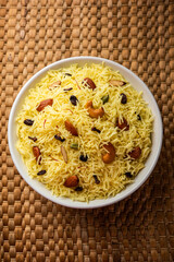 Kashmiri sweet modur pulao made of rice cooked with sugar, water flavored with Saffron and dry fruits