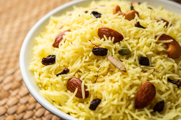 Kashmiri sweet modur pulao made of rice cooked with sugar, water flavored with Saffron and dry...