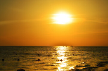 the sea at sunset. nature in the evening. dark water. summer vacation. background for the design. orange light.