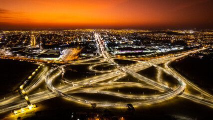Ribeirão preto brazil viaduct, drone showing streets and avenues at sunset. Car light streak.