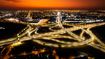 Ribeirão preto brazil viaduct, drone showing streets and avenues at sunset. Car light streak.
