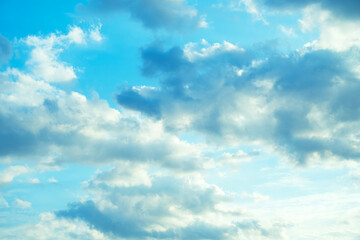 Sky background, blue with fluffy white clouds, covered, bright horizon, from the summer sun.
