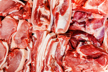 Pieces of pork on the counter in the store. Trade in fresh meat in a retail network. Close-up