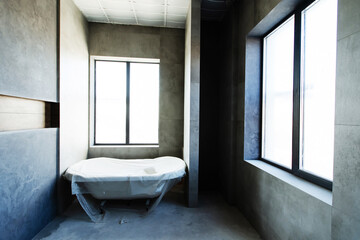 Repair and construction of a bathroom. The interior of the room is lined with large, ceramic tiles. Interior decoration of a house or apartment. selective focus