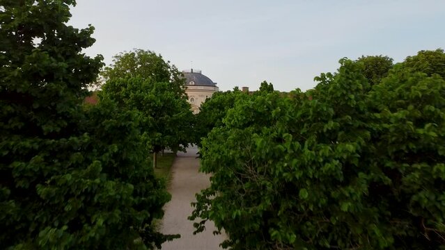 drone shot of a tree alley ends with the Schloss Solitude (castle)