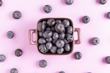 Ripe sweet blueberries on a purple background.