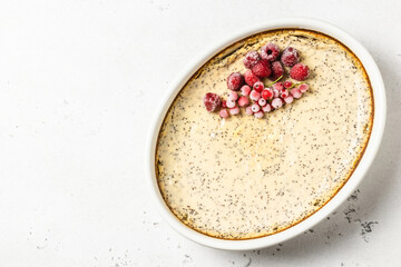 Healthy dessert, cottage cheese casserole, poppy seeds, frozen berries. Top view, copy space.