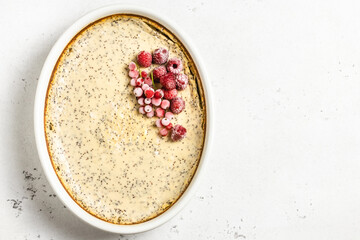 Healthy dessert, cottage cheese casserole, poppy seeds, frozen berries. Top view, copy space.