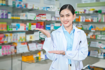 Portrait of female pharmacist working in a modern pharmacy drugstore.