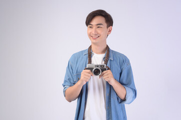 Young happy asian tourist man over white background studio, travel and holidays concept.