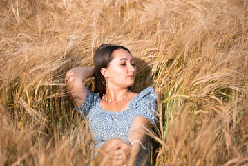 Portrait of happy girl in wheat field, nature of Ukraine. Growing grains for agricultural aims.Summer time 