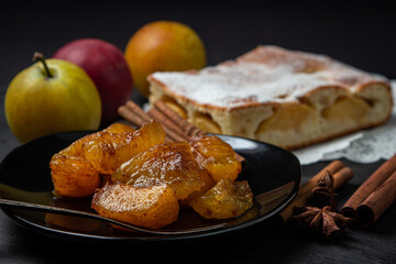 Plum dessert on a black background. Fruit home cooking. fruit dessert