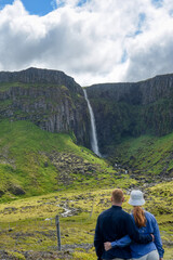Couple viewing Grundarfoss in Iceland