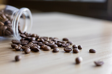 coffee beans in glass battle on wooden table 