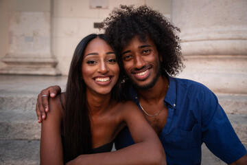 Portrait of an east african couple, smiling lovers cuddle each other. - obrazy, fototapety, plakaty