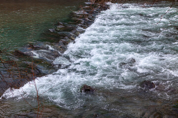 Flowing river water with cascade .  Waterfall in a stream where water flows