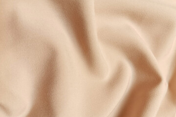 Fototapeta premium Beige galliano fabric crumpled or wavy fabric texture background. Abstract linen cloth soft waves. Viscose yarn. Smooth elegant luxury cloth texture. Concept for banner or advertisement.