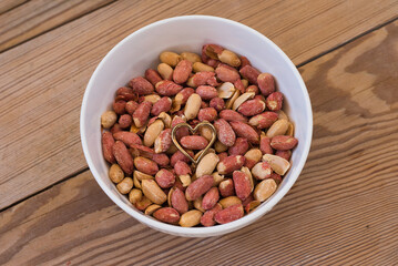 salted peanuts on wooden table.