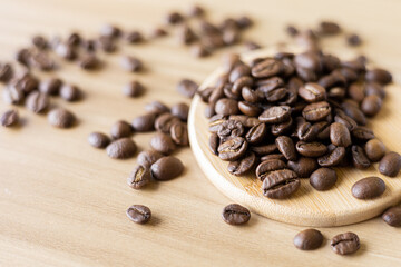 close up of coffee beans roasted on wooden table 