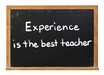 Experience is the best teacher written in white chalk on a black chalkboard isolated on white