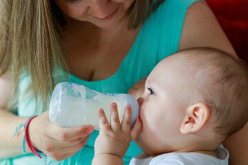 Baby boy drinking milk from bottle