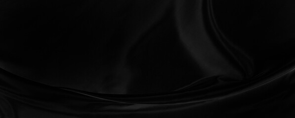 Black gray satin dark fabric texture luxurious shiny that is abstract silk cloth panorama background with patterns soft waves blur beautiful.