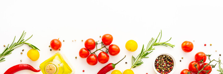 Yellow and red tomatoes, hot peppers, rosemary and spices on a white background, food banner, top view, copy space