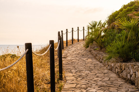 Nice cobbled path with wooden poles with white rope.