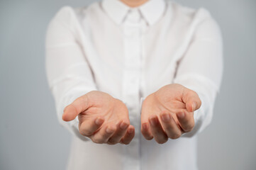 Close-up of caucasian woman holding her palms up. 