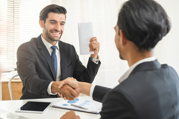 Handshake, caucasian male giving financial reward in an envelope, business letter extra salary to...
