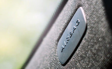 The embossed Airbag logo on a plastic plate on the windshield pillar of a modern car. The airbag is a passive safety device installed in cars to protect passengers from collisions 