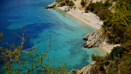 Fototapeta na wymiar Crystal clear waters with sandy beaches and secluded bays.Along the Ionian coast is the most beautiful sea where the rugged coast offers magnificent bays with sandy or pebble beaches with a blue-green
