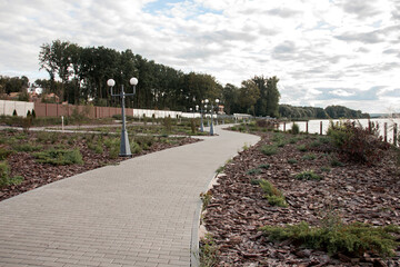 modern park near river. city promenade for walking. landscape design of the park area along the river