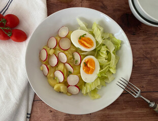 Summer salad. Radish potato salad with boiled egg. Vegetarian, classic.