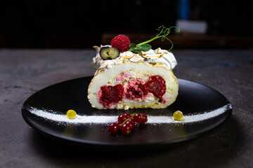 Meringue roll with delicate air cream and raspberry fruit filling.