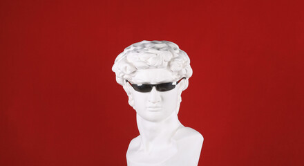 ancient sculpture of a head with glasses