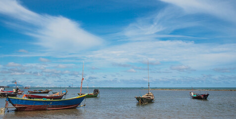 landscape view Small fishing boat parked on the coast of the sea. after fishing of fishermen in a...