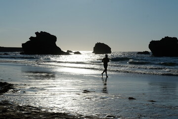 The silhouette of a man running on the beach. The 8th July 2022, Biarritz, France.