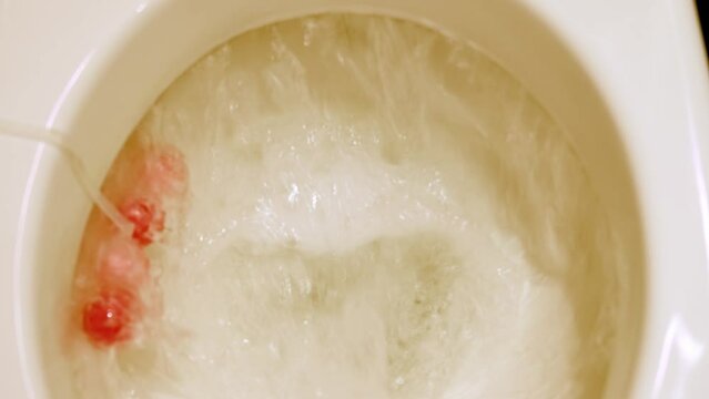 white faience toilet bowl, home toilet, disinfectant flavoring balls on the side of the toilet bowl, the concept of natural human needs, relieve yourself, clogged sewage, house cleaning