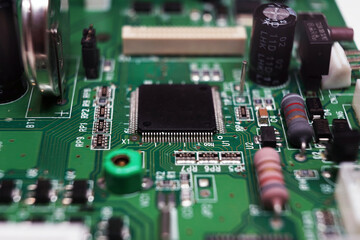 Printed Circuit Board with many electrical components. Selected focus.