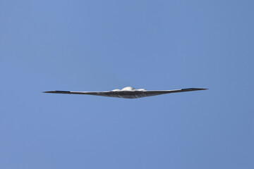 Unusual frontal view of a B-2 Spirit  stealth bomber in beautiful light 