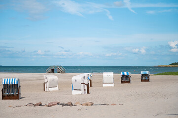 Sunny beach with white sand and wicker beach chair in north Germany