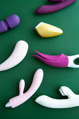 Collection of different types of sex toys on a green background.  - 518838411