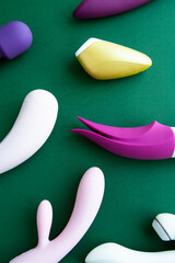 Collection of different types of sex toys on a green background.  - 518838436