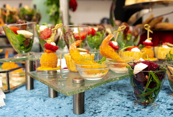 snacks and salads on the buffet table. catering at the event.