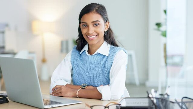 Portrait of a young entrepreneur networking with clients online using her laptop. One happy female corporate intern browsing the internet and typing and sending emails for her manager