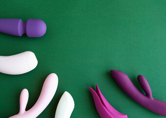Collection of different types of sex toys on a green background.  - 518838610