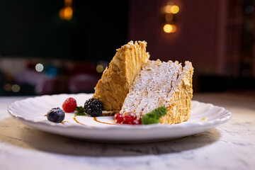 napoleon cake with berries. serving dessert in a restaurant
