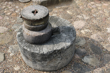 Old ancient stone mill. Millstones for grinding wheat or other grains, grinding stones. - obrazy, fototapety, plakaty