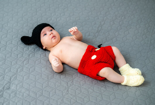 Adorable Cute Baby Lying In Mickey Mouse Costume. First Birthday.